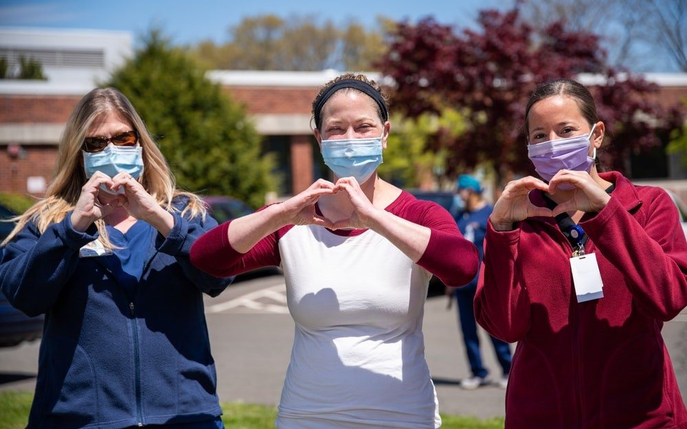 Healthcare Providers making Heart Symbols with Hands
